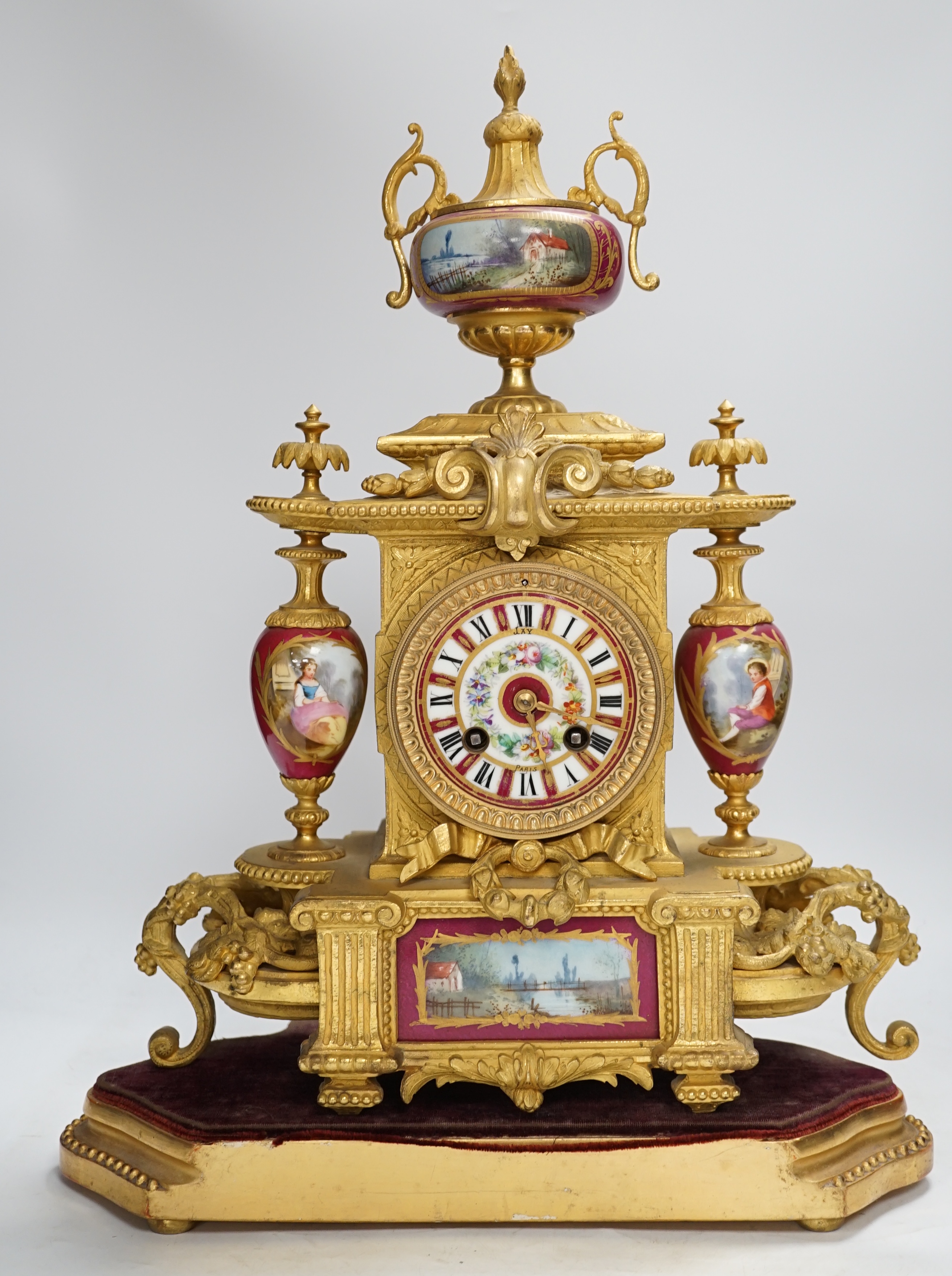 A late 19th century gilt spelter and porcelain mantel clock with two stands, a case, key and pendulum. Condition - fair to good. Not tested.
